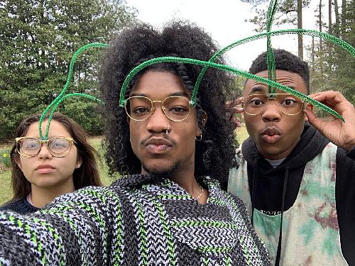 three male students wearing glasses on their green antennae